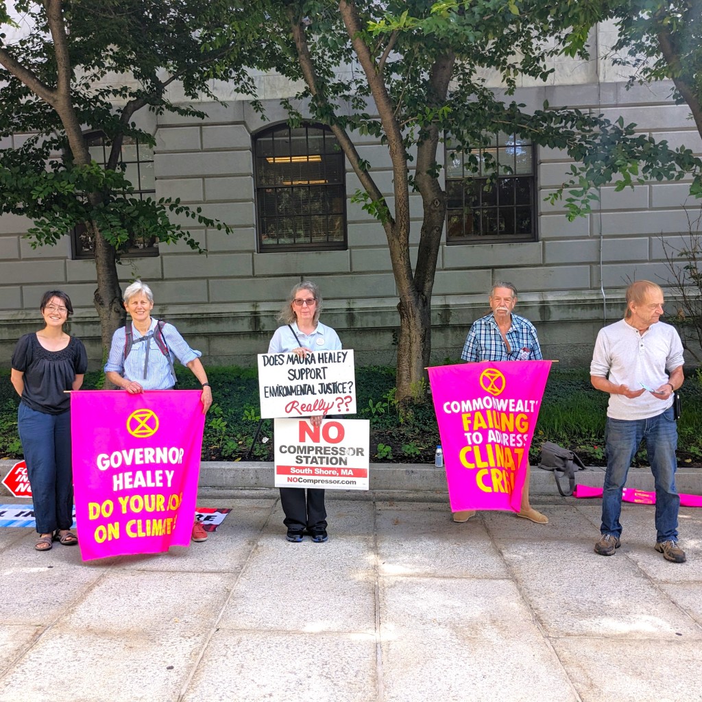 August 9th: A ‘fearsome foursome’ of activists today. What does the whiteboard say to passerbys? “Sorry to disturb you, but this is an emergency. We must end our reliance on fossil fuels NOW, starting with a ban on all new fossil fuel infrastructure!”